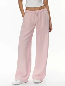 Detail of light pink linen wide-leg pants with elastic drawstring waist and pocket design
