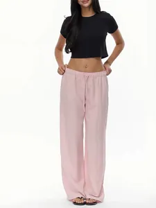 Detail of light pink wide-leg linen pants featuring an elastic drawstring waistband