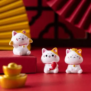 Three-piece lucky cat resin figurine set for home decor with golden and red accents