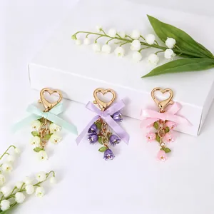 Floral lily of the valley keychains with satin bows and heart clasps in three colors