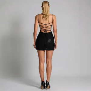 Elegant black backless mini dress with lace-up cross straps and delicate bow detail
