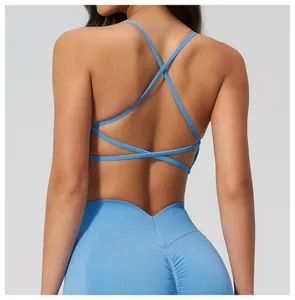 Detail view of sky blue seamless yoga set with cross straps and ruched bum leggings