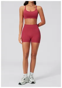 Detail shot of seamless burgundy sports bra and high-waist shorts on female model