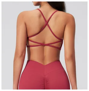 Detail of burgundy cross-back sports bra and high-waisted leggings with ruched back