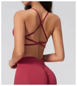 Detail of cross-back sports bra and high-waisted shaping yoga leggings in rose red