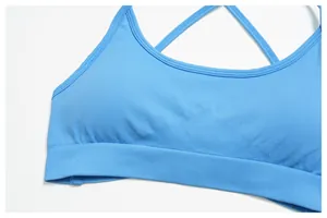 Detail view of bright blue seamless ribbed yoga bra with criss-cross back straps