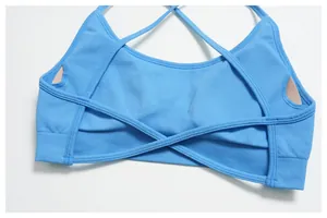 Detail of blue yoga bra featuring ribbed texture and thin cross-back strap design