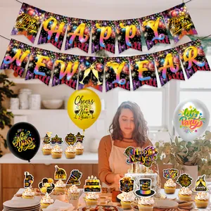 Close-up of Happy New Year party set with gold balloons and glitter cupcake toppers