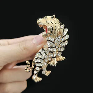 Macro shot of gold tiger brooch with sparkling rhinestones and black enamel details