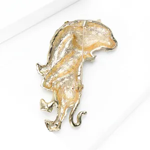 Back view of gold plated tiger brooch with secure rotating pin clasp on white blocks