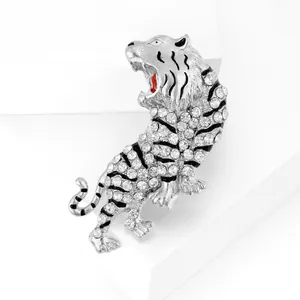 Macro shot of silver tiger brooch with white rhinestones and black enamel detail