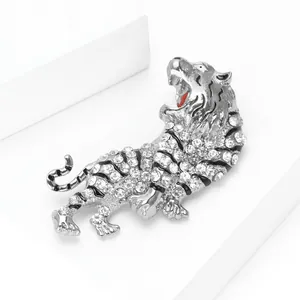 Detailed macro view of silver tiger brooch with white rhinestones and black enamel