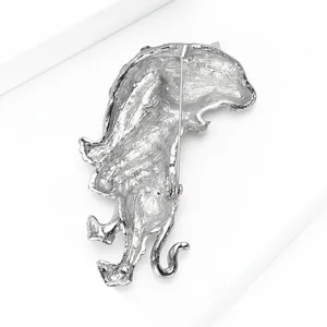 Detailed back view of silver tiger brooch showing metal texture and pin fastening