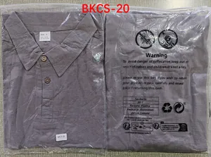 Men's purple linen polo shirt in protective packaging showing collar and wood buttons