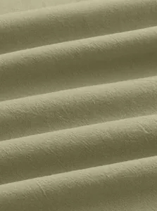 Close-up of breathable linen-cotton fabric texture in pale green for polo shirts