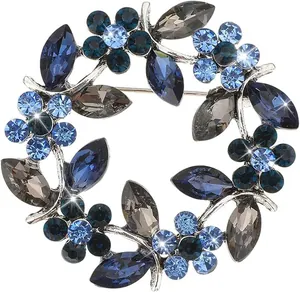 Detail of flower wreath brooch with blue crystal petals and marquise cut stones