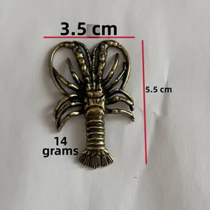 Macro detail of brass lobster tea pet showing vintage bronze finish and dimensions