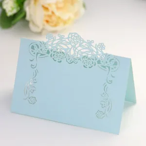 Macro detail of laser-cut light blue floral table place card with pearl finish paper