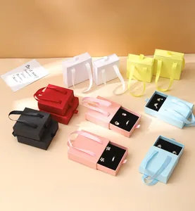 Colorful jewelry drawer boxes with ribbon handles and velvet sponge inserts