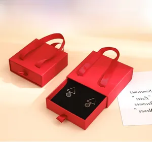 Macro view of red jewelry drawer gift box with elegant ribbon handle and lining