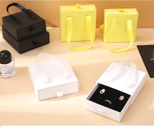 Detail of drawer-style jewelry gift boxes with ribbon handles and soft lining