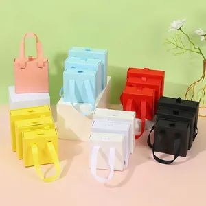 Multi-colored drawer jewelry boxes with ribbon handles in various sizes for rings and necklaces