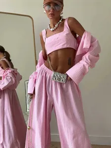 Pink striped three-piece set with cropped top, loose pants, and cardigan shirt