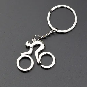 Polished silver metal bicycle keychain for sports enthusiasts on gray background
