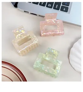 Three-piece set of square pastel hair claws in pink, cream, and mint with marble texture