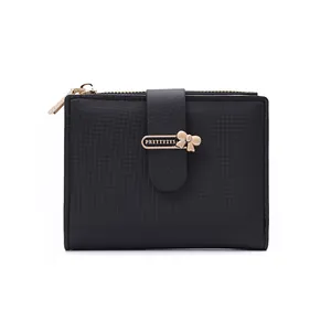 Close-up of black PU leather wallet with zipper, metal logo and bow pendant detail