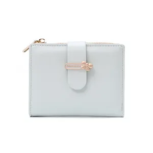 Close-up of mint blue short PU wallet featuring gold bow buckle and metal zipper