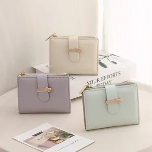Short PU leather wallet with snap closure, bow detail, and side zipper for coins