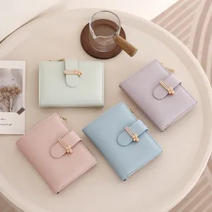 Close-up of pastel PU leather wallets with bow metal clasp and zipper details