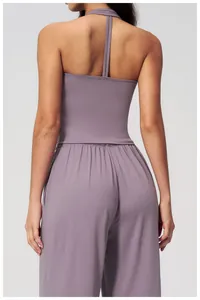 Detail of cross-back yoga top and high-waist wide-leg pants in soft purple-grey fabric