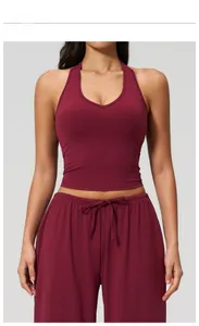 Close-up of cherry red V-neck yoga tank top and high-waist pants with drawstring details