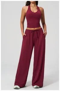 Detail of burgundy halter top and high-waisted wide-leg pants for yoga and fitness