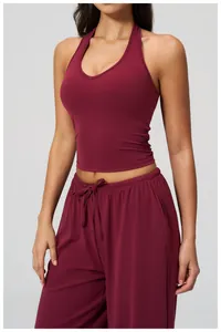 Detail of maroon high-elastic yoga tank top and wide-leg trousers for fitness workout
