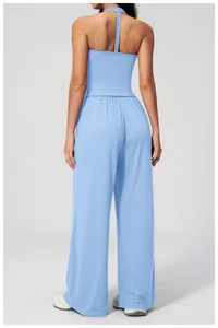 Detail view showing the back of light blue brushed yoga vest and high-waist yoga pants