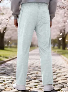 Detailed view of grey jogger waist and back pocket against a cherry blossom background