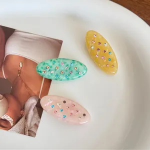 Three-piece oval acetate hair clips set with colorful rhinestones in macaron colors