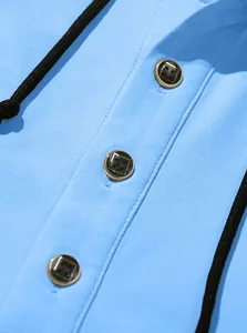 Macro view of light blue twill hoodie neckline with three decorative gold-rimmed buttons