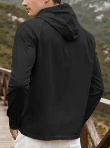 Detail of men's black hooded jacket showing back tailoring and drawstring hood