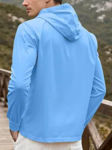 Back view of light blue men's hooded sweatshirt in a scenic outdoor mountain setting