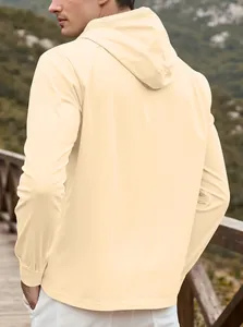 Outdoor shot of men's beige hooded cardigan with elastic cuffs and mountain view