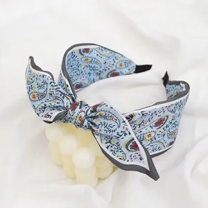 Retro light blue paisley pattern headband with double layer bow and satin texture