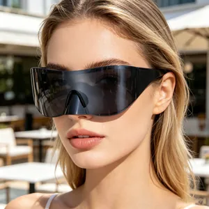 Close-up of black oversized wrap-around sports sunglasses with Y2K shield design
