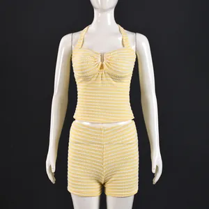 Detail of yellow and white striped knit halter top and high-waist shorts set