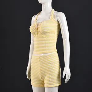 Detail of yellow and white striped knit texture on halter top and high waist shorts