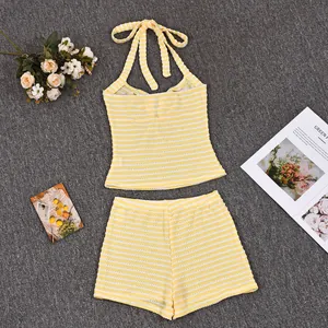 Flat lay of yellow striped knit two-piece set with halter top and elastic shorts