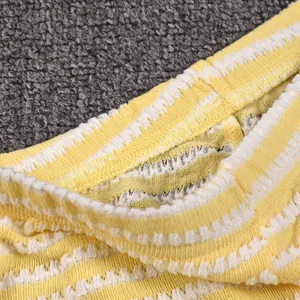 Close-up of vibrant yellow and white striped elastic knit cuffs with ribbed texture